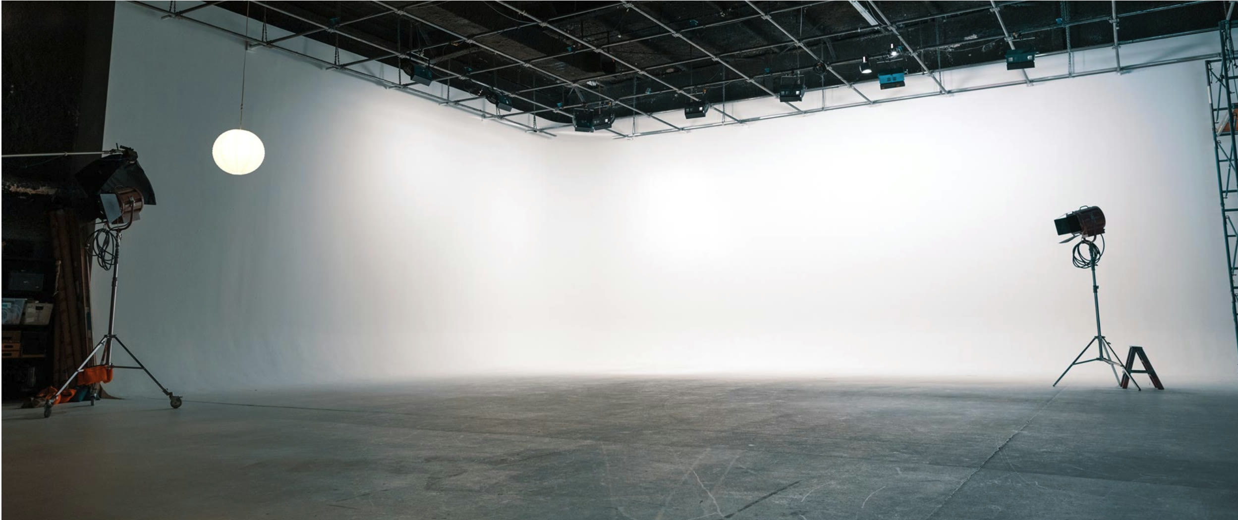Trailblazer Studios stage - large white cyc wall, overhead lighting grid, polished concrete floor